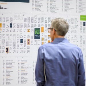 A person looking at a large white board

Description automatically generated